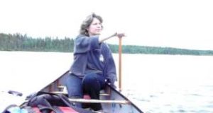 In-a-canoe-Crystal-demonstrates-the-Indian-paddle-stroke-in-Saskatchewan-Canada.